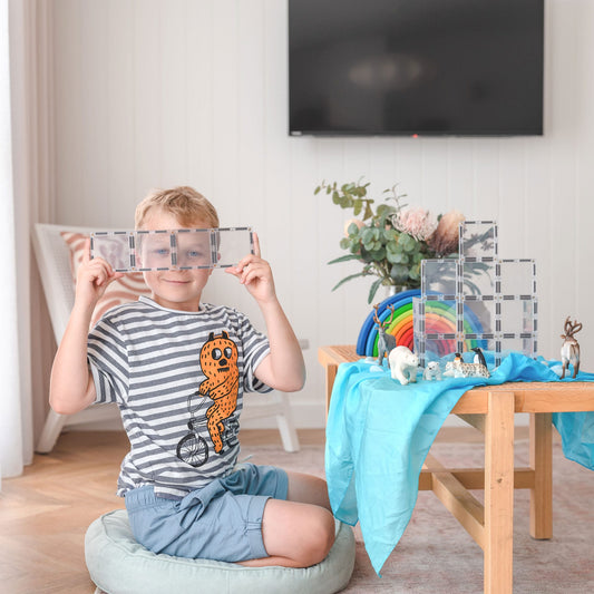 Child holding a transparent cube