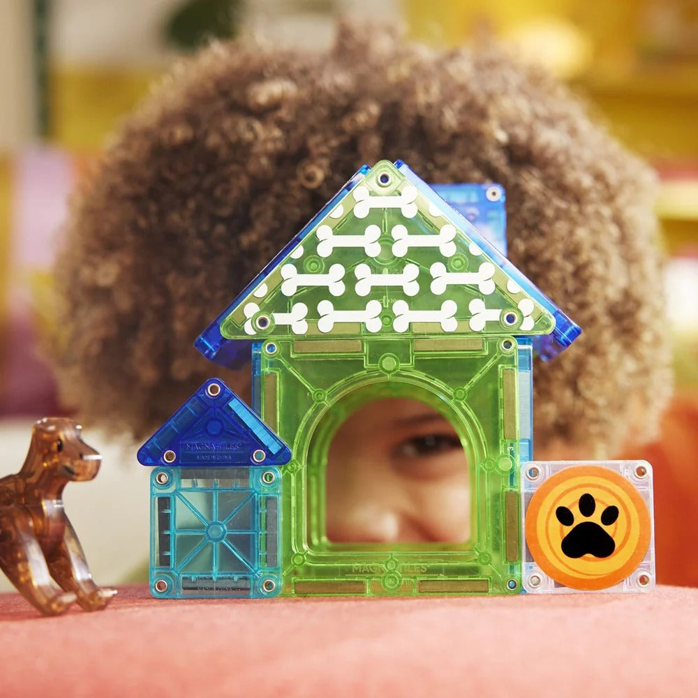 Child playing with transparent doghouse toys