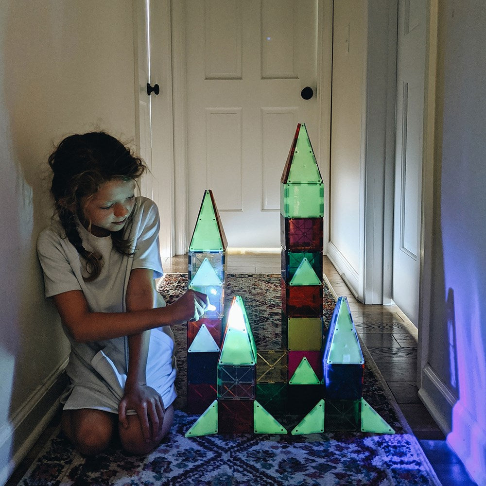 Child playing with colorful geometric blocks 