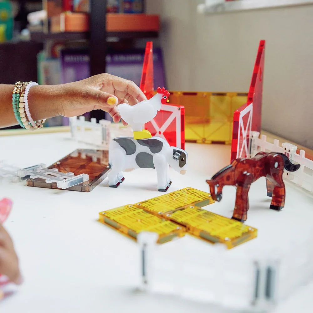 Toy farm set with animals and a hand interacting 