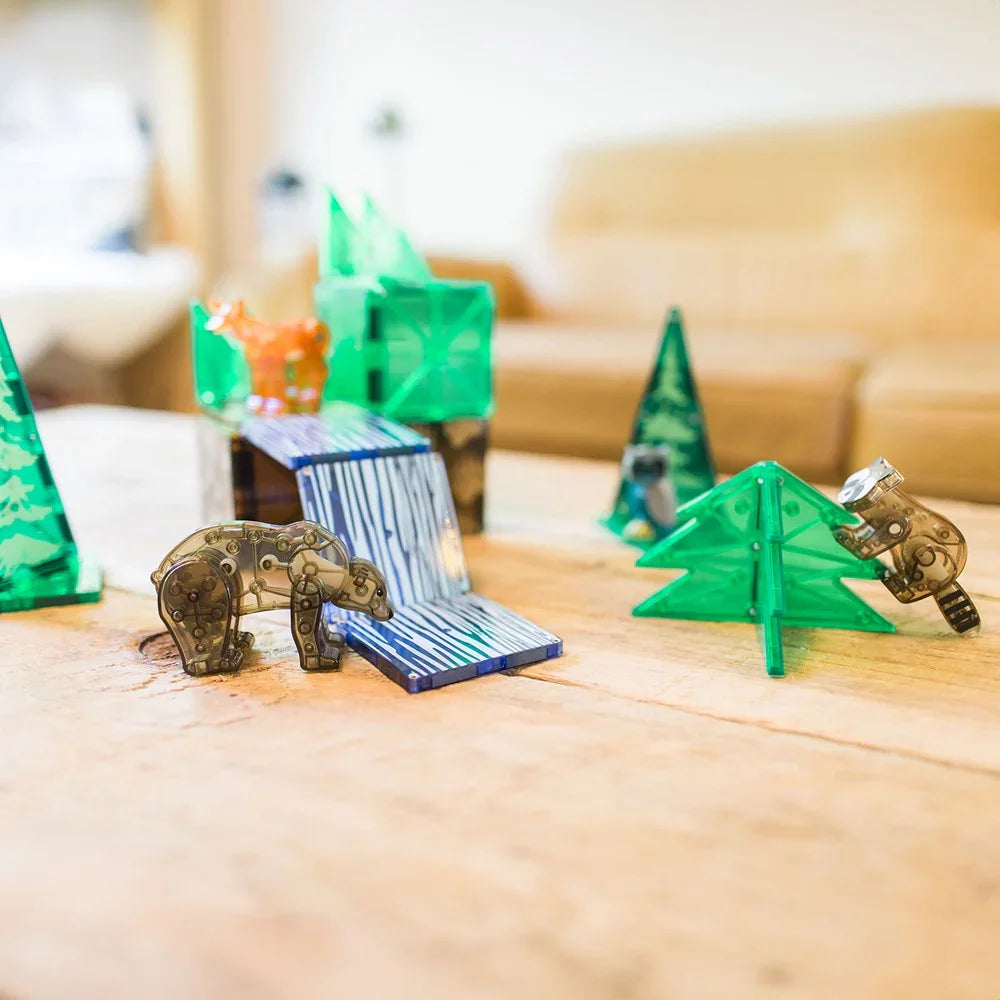 Toy setup with green trees and a blue slide 