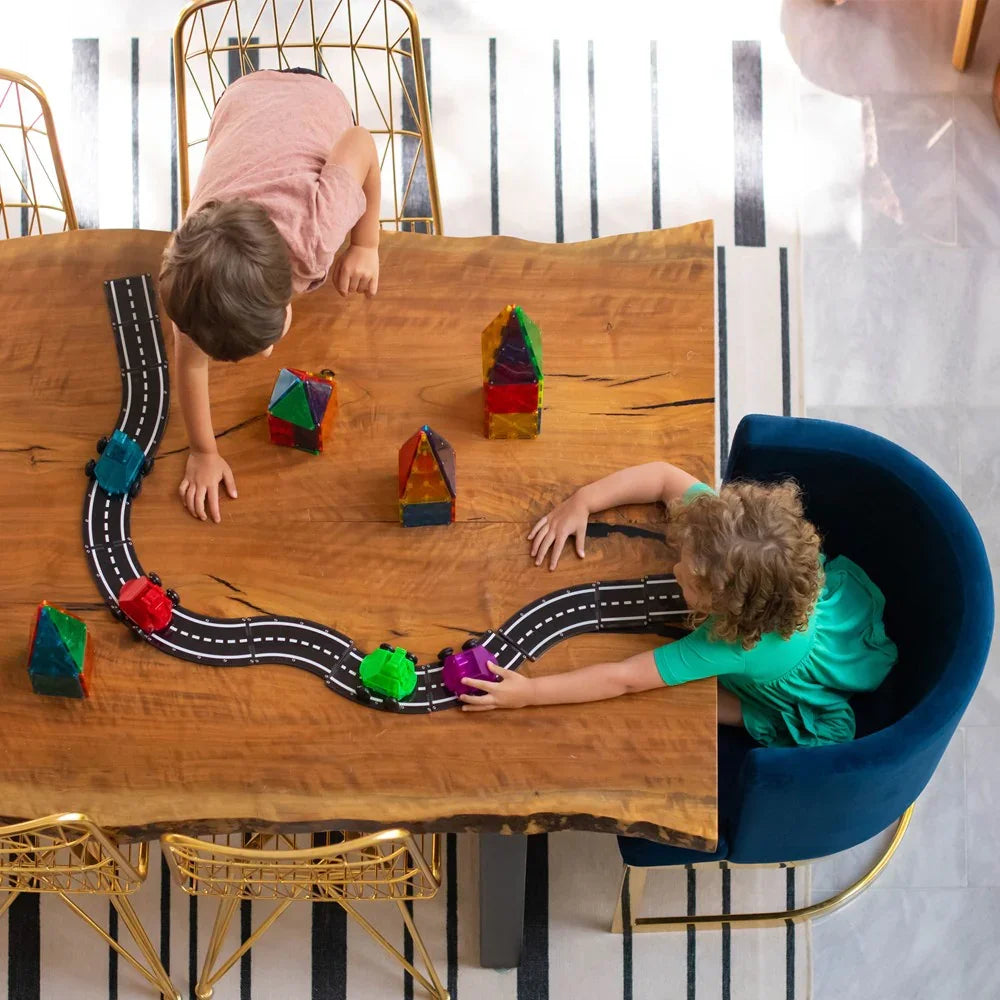 Two children playing with a toy road 