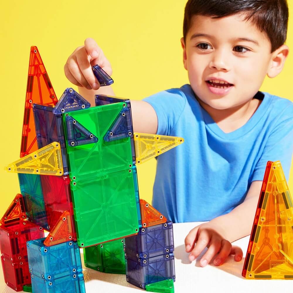 Child playing with colorful magnetic building blocks