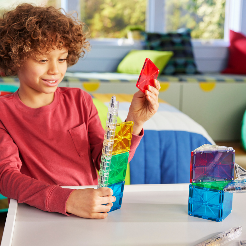 Child playing with colorful building blocks 