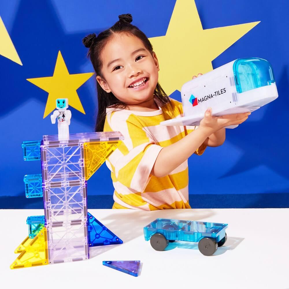 Child playing with Magna-Tiles toy set 
