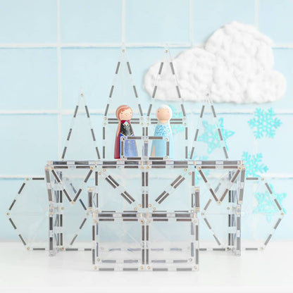 Model of a building with two figures on top against a light blue tiled wall with cloud and snowflake decorations