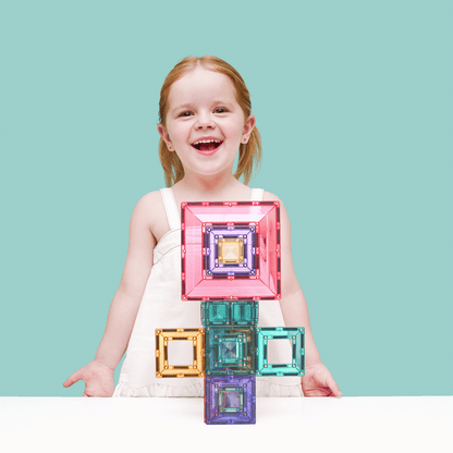 Child holding colorful geometric blocks 