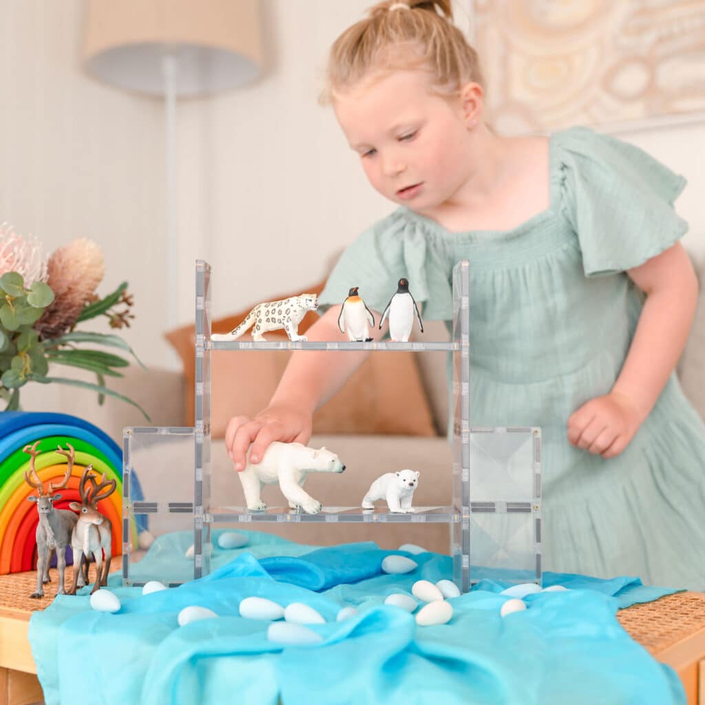 Child playing with animal figurines