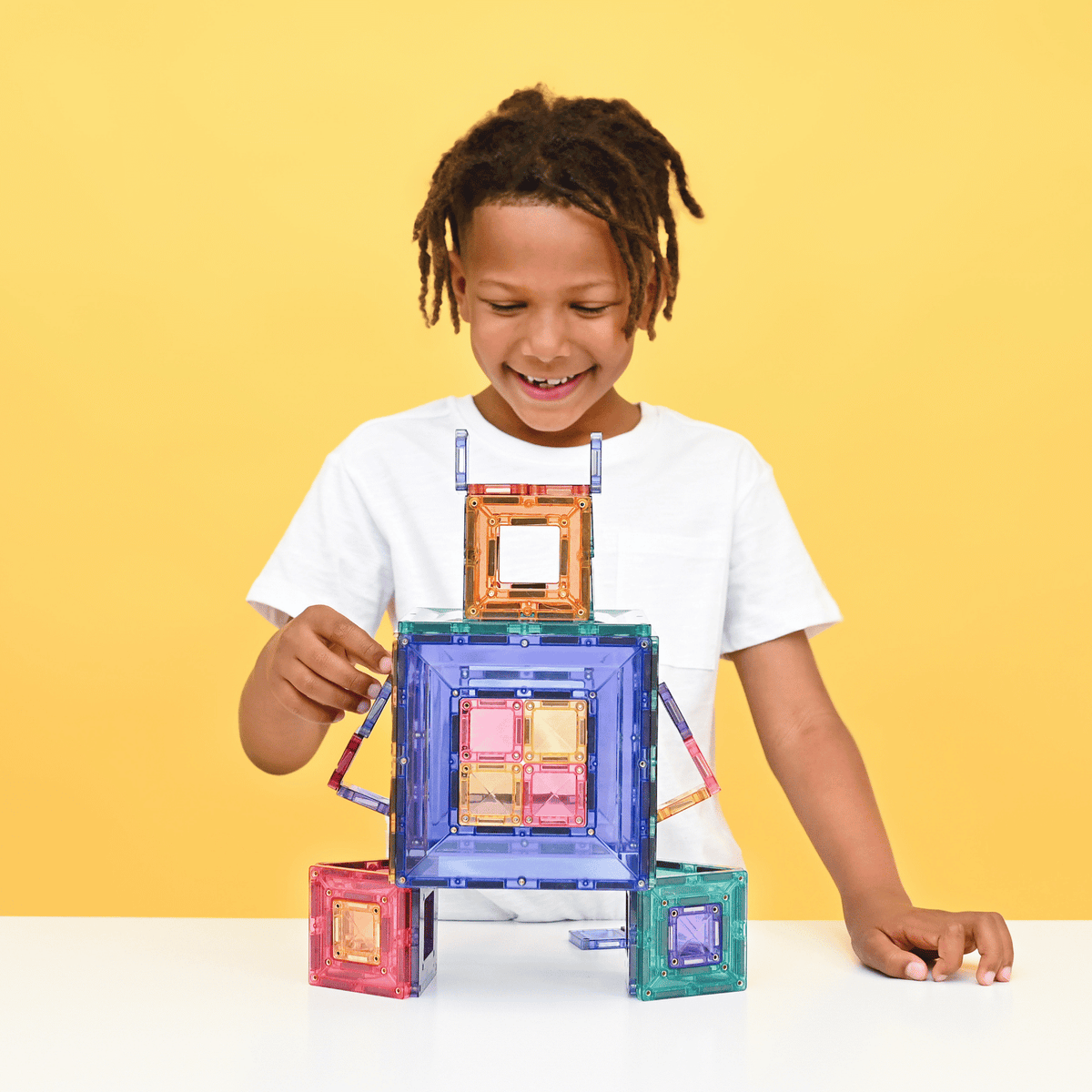 Child playing with colorful magnetic building blocks 