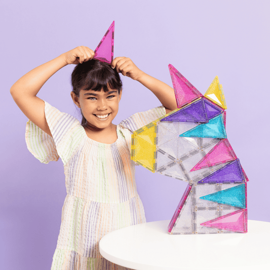 Child playing with colorful geometric building blocks 