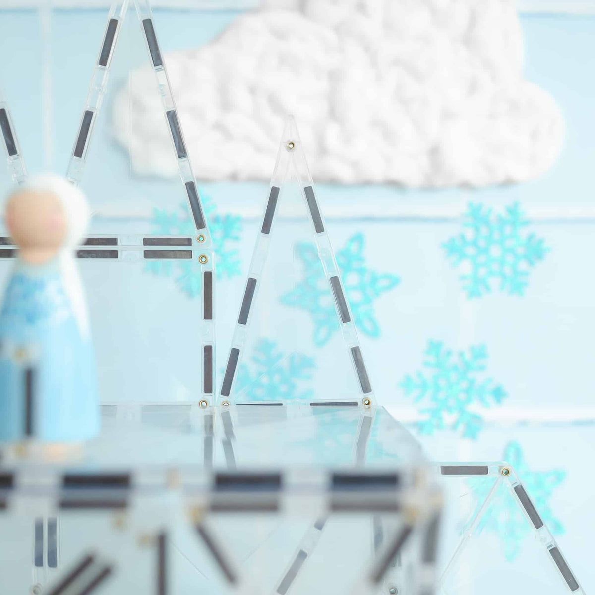Close-up of a clock with snowflake decorations 
