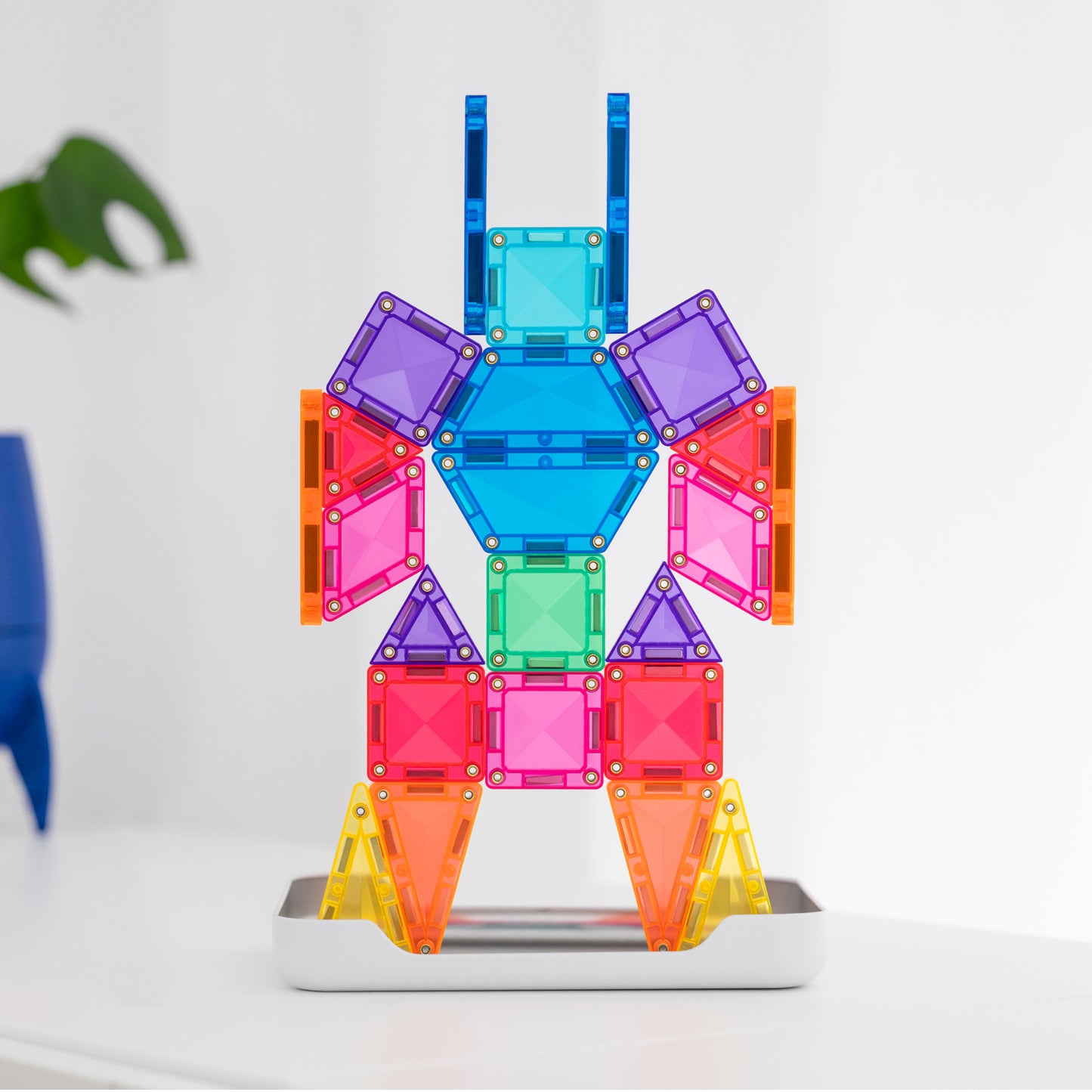 Colorful magnetic building toy assembled into a humanoid robot figure, standing