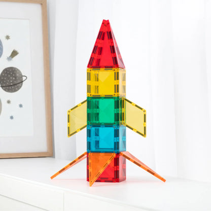 A colorful toy rocket built from translucent magnetic building blocks, standing 