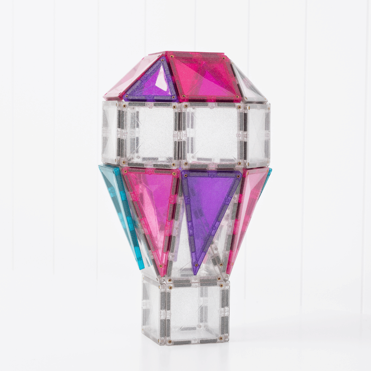 Colorful geometric vase with pink, purple, and blue facets 
