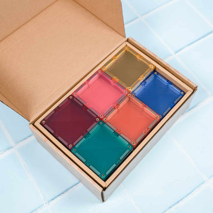 Set of colorful transparent square blocks in a cardboard box 
