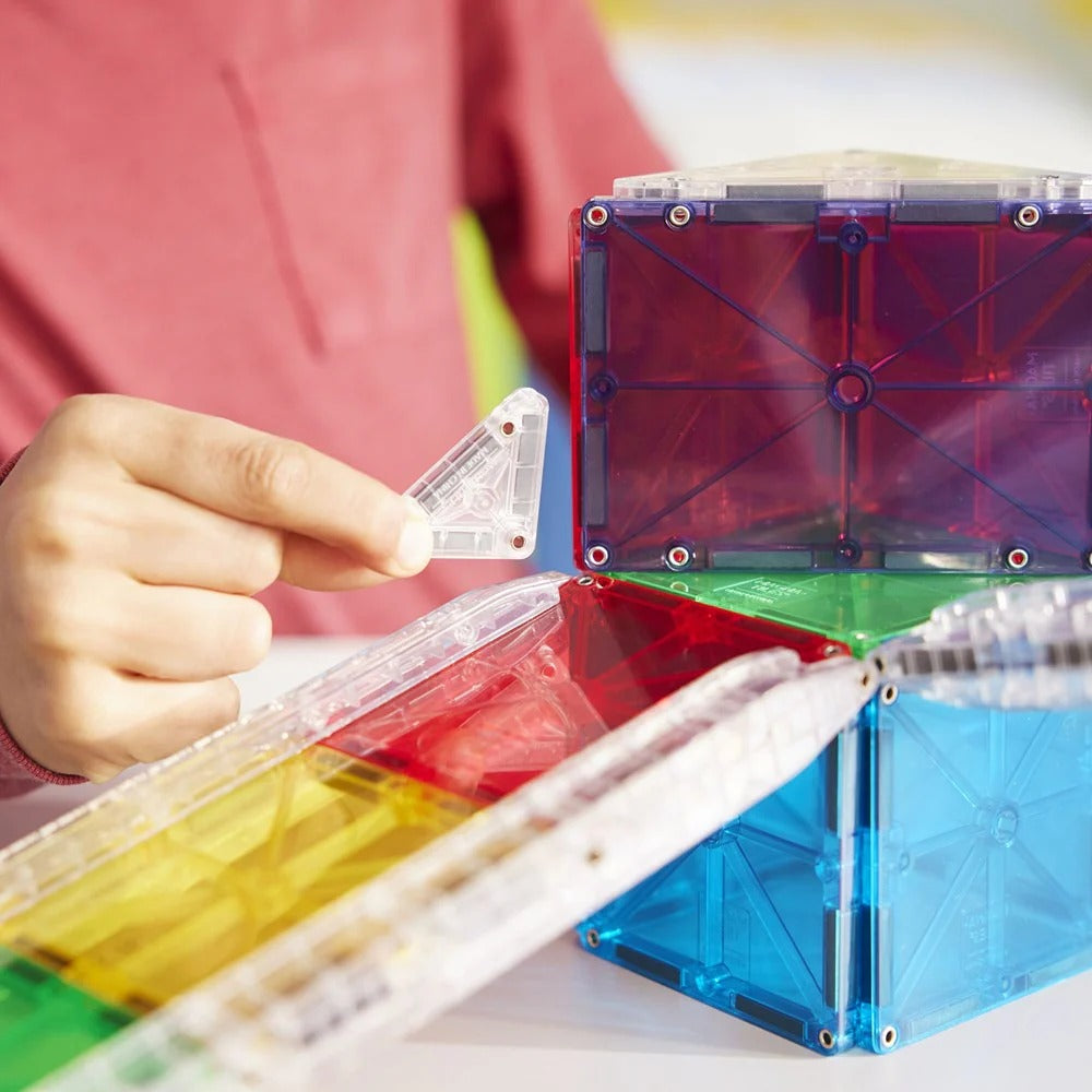 Colorful magnetic building blocks being assembled with a child's hand