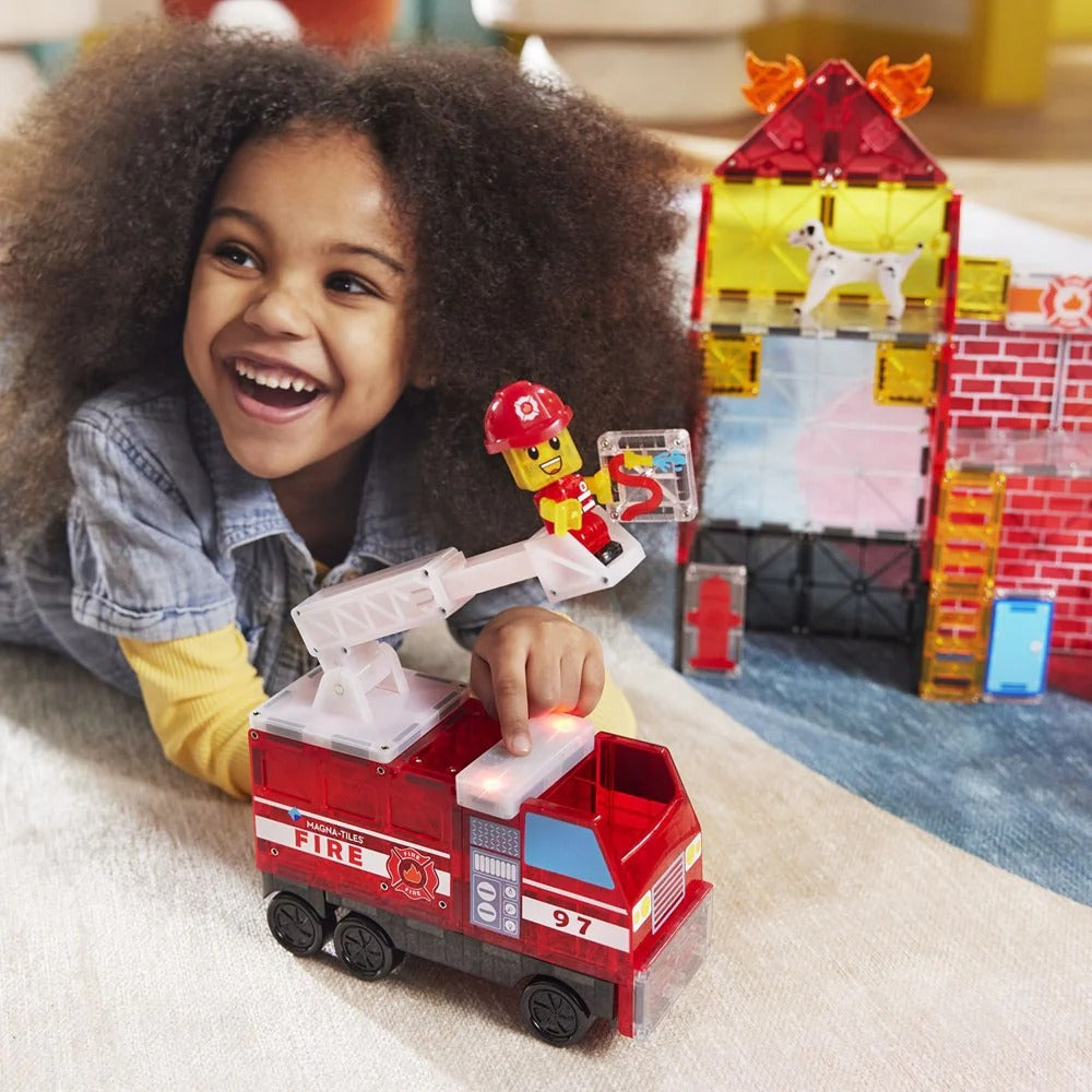 Child playing with a toy fire truck 