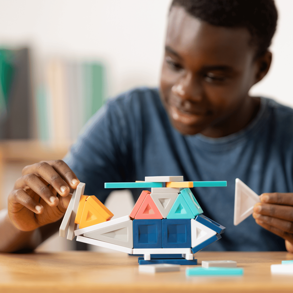 Person playing with geometric building blocks 