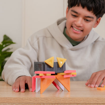 A smiling young man sits 