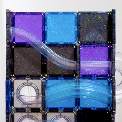 A close-up of a transparent block puzzle or magnetic tile assembly with curved clear plastic channels