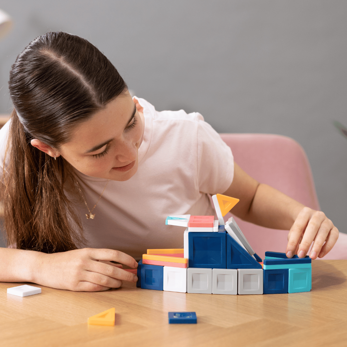 Woman playing with colorful building blocks 